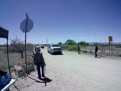 Members of the Willcox Seventh-day Adventist Church stand alongside the road leading away from the event to pass out the bags.