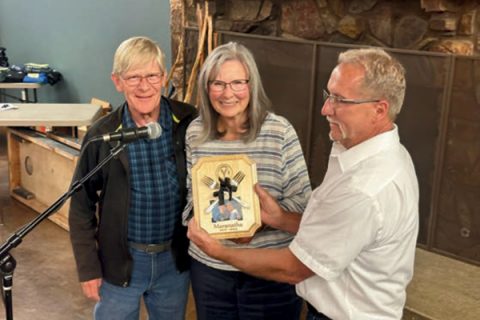 Scott Blake presents John and Carolyn Houghton with a special plaque commemorating their seven years as project leaders for the Camp Yavapines Maranatha Volunteers Project.