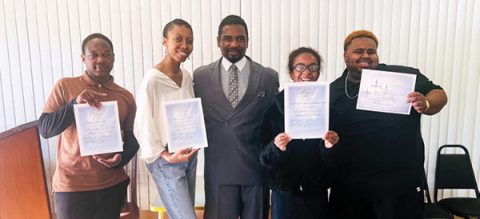 The newly baptized members display their baptism certificates. Left to right: Michael Lewis, Hannah Render, Pastor Frazier, Zhaniah Tamplin, and Miles Frazier.