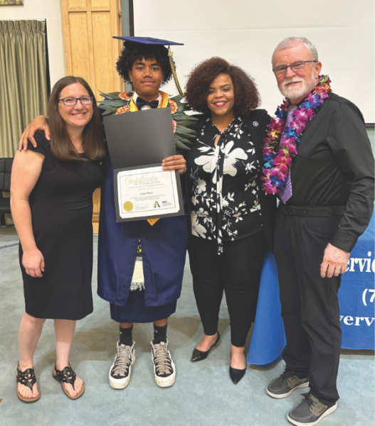 The Riverview Christian Academy graduate poses with (from left) the principal, the NUC executive secretary, and his teacher.