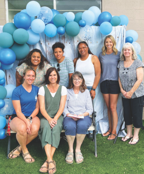 Cindy Myers (sitting in the middle, wearing green) is celebrated for her years of service in Adventist education.