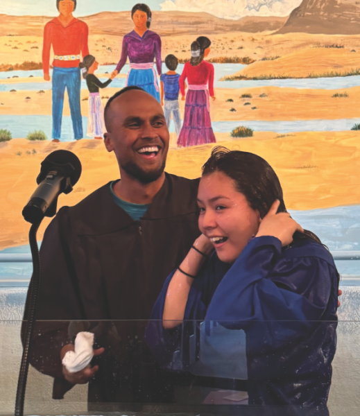 Pastor Steven Sigamani (left) baptizes La Vida student Talise Mescal, a senior.