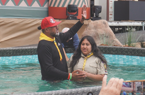 SECC Associate Youth Director Meshach Soli baptizes a Pathfinder.